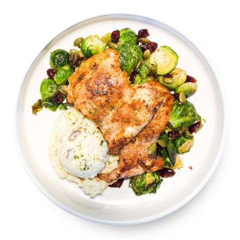 Chicken thighs with cranberry brussels sprouts and potatoes, a gluten-free dairy-free luxe + lemons entree